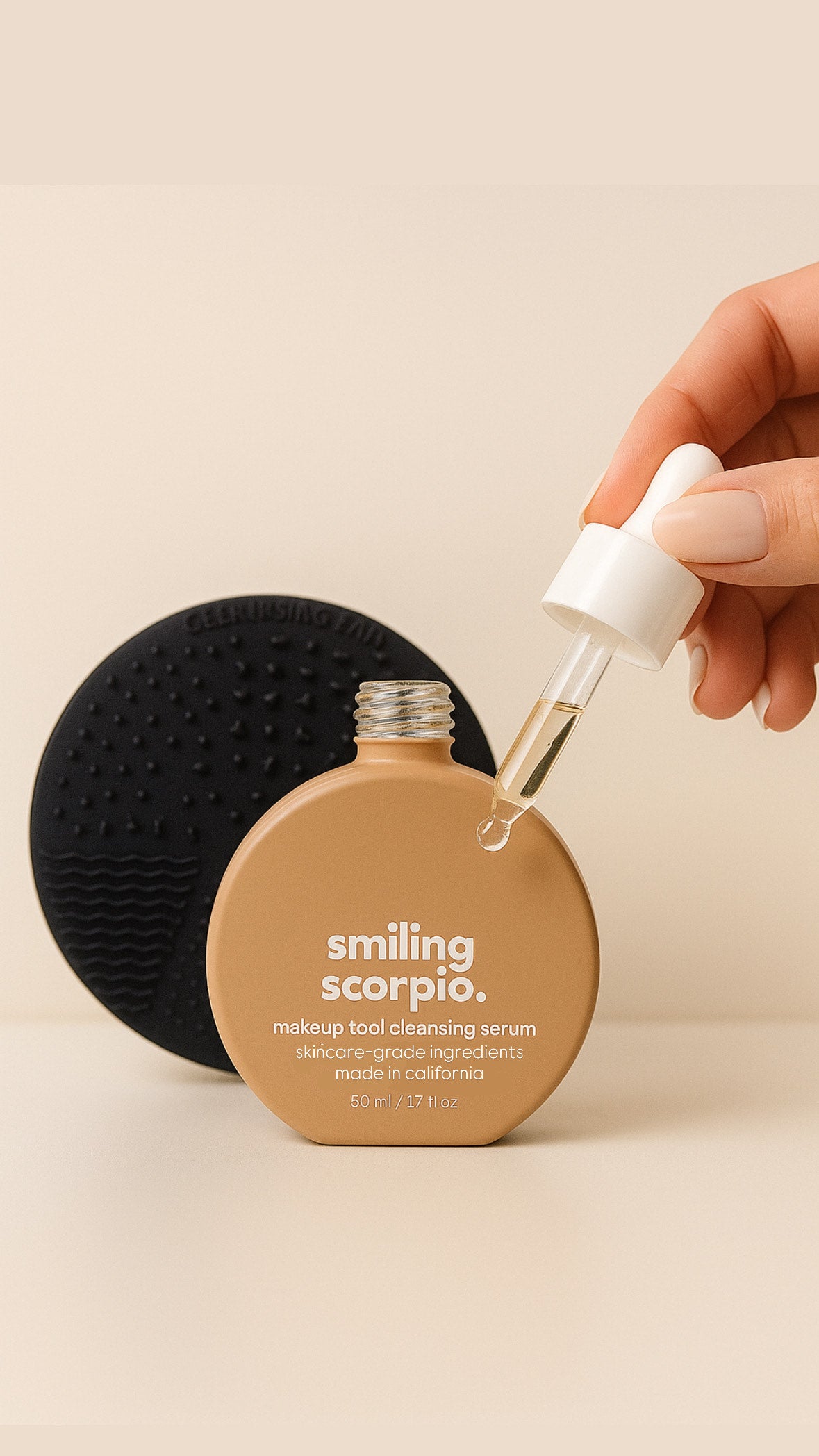smiling scorpio 50ml makeup brush cleansing serum bottle with dropper and cleansing pad on beige background